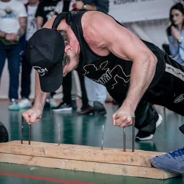 Focused man doing a challenging balance and strength exercise.