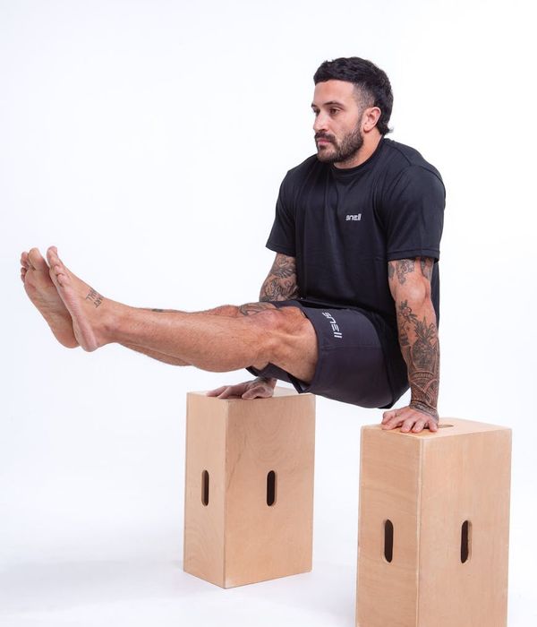 Man performing a controlled strength exercise in a calm environment.